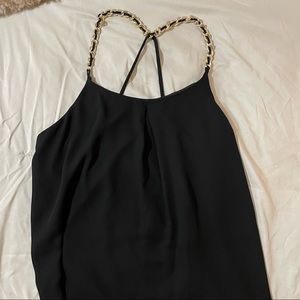 Black tank top with gold jewelry.